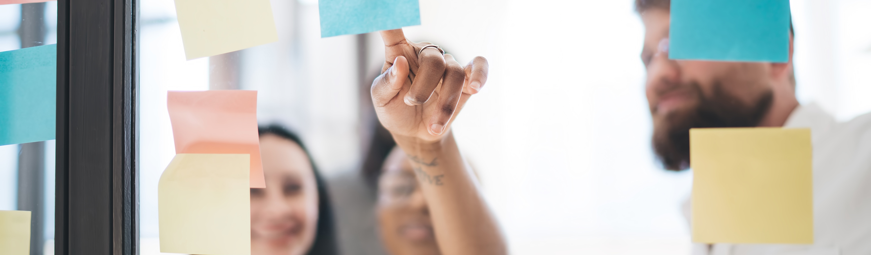 Colleagues pointing at post its